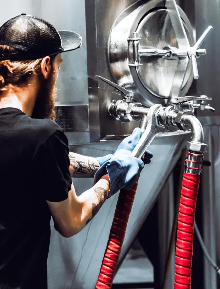 a worker tightening a valve